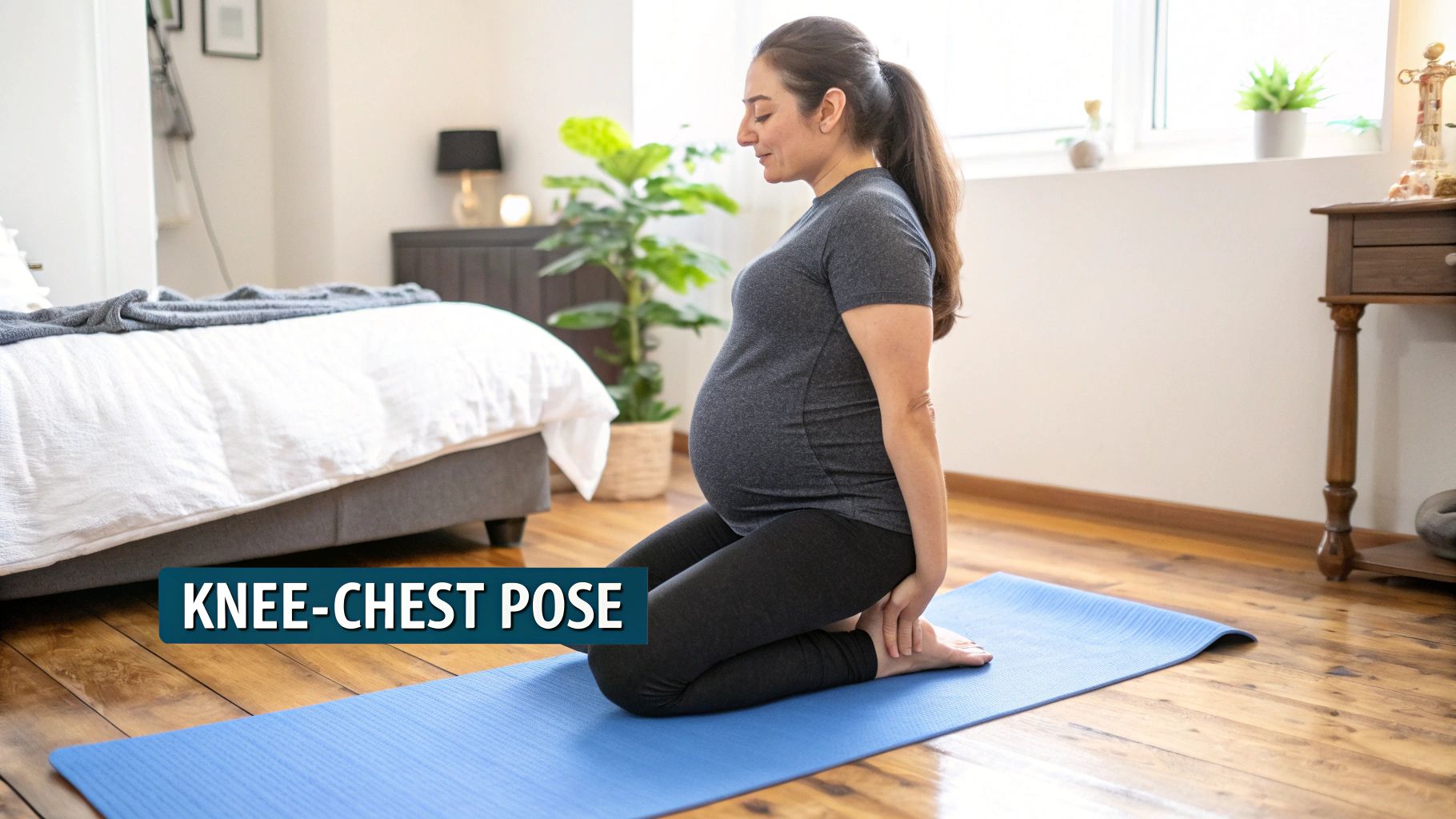A pregnant woman in the knee-chest position on a yoga mat.