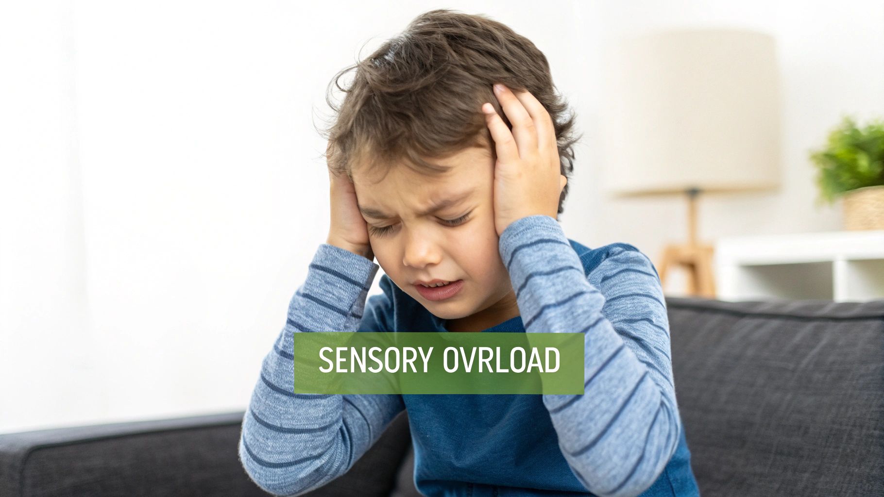 Child covering ears, looking overwhelmed by sensory input
