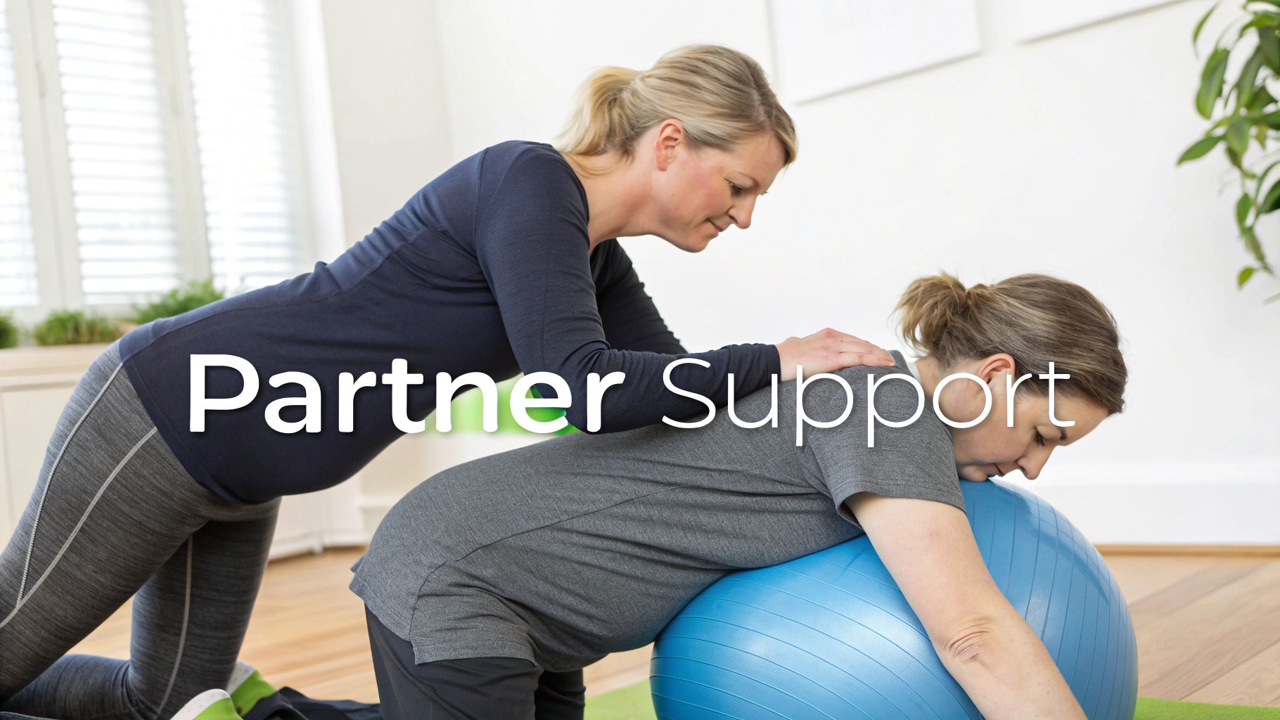 A pregnant woman leans on an exercise ball while another woman provides supportive touch.