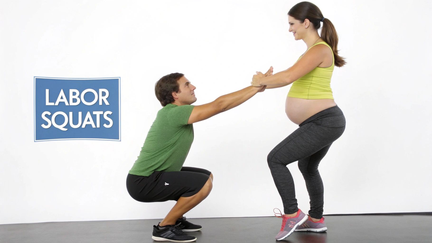 A man helps a pregnant woman perform labor squats, an exercise to prepare for childbirth.