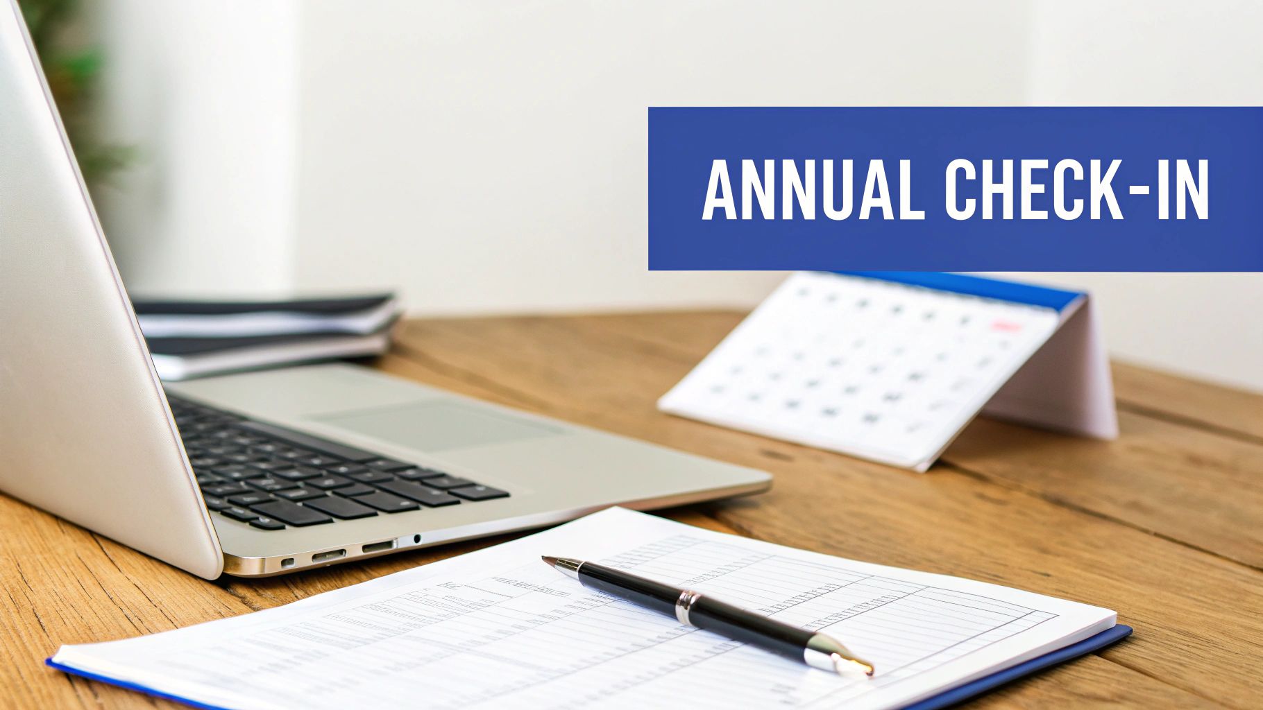 A person working on a laptop with charts and graphs, representing business compliance and filing.