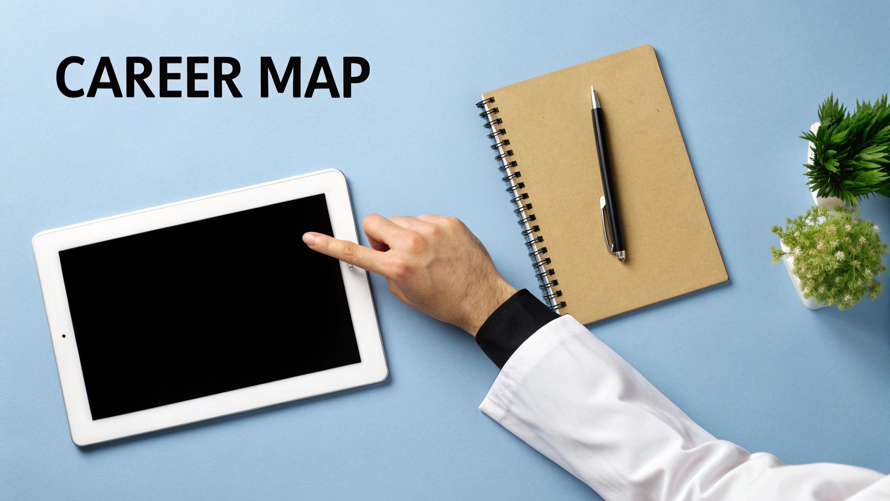 Overhead view of a person touching a tablet, with a notebook, pen, and plants. Text: CAREER MAP.