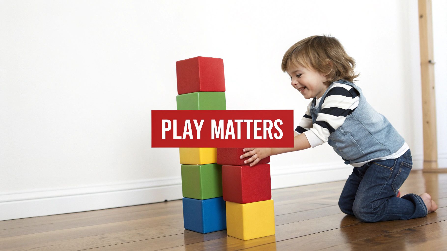 A happy child playing with colorful building blocks on a wooden floor, enjoying playtime.
