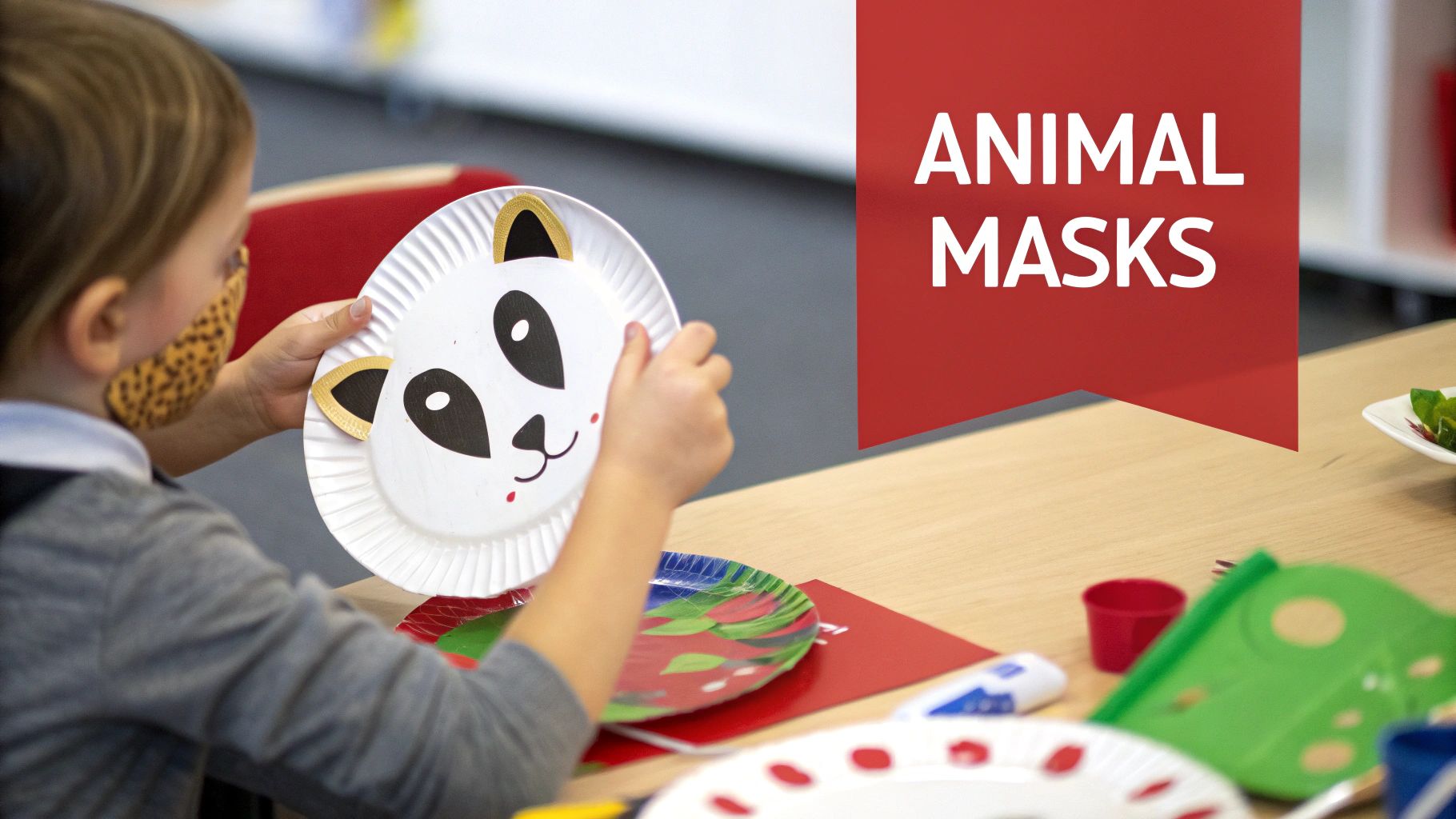 A child holds a white paper plate crafted into a panda mask during a fun crafting activity.