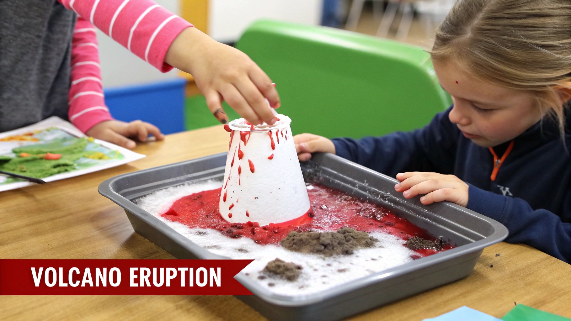 Two children actively participate in a fun, messy volcano eruption science experiment in a classroom.