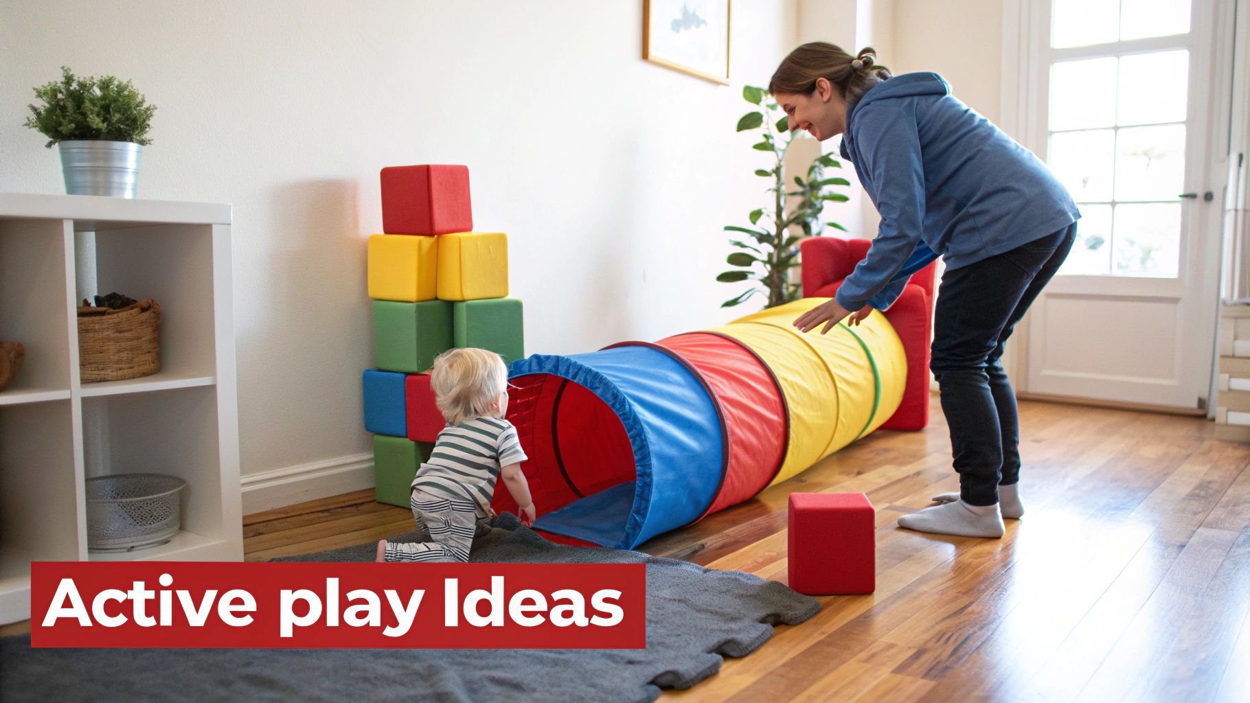 A happy woman and a toddler playing with a colorful play tunnel and blocks on a rug.