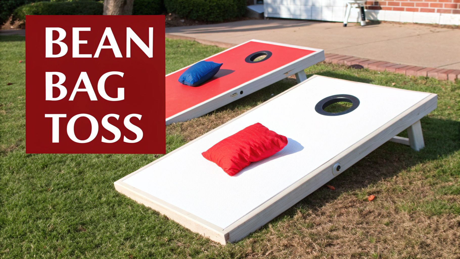 Two cornhole boards, one red and one white, with bean bags on a grassy lawn, with 'BEAN BAG TOSS' text.
