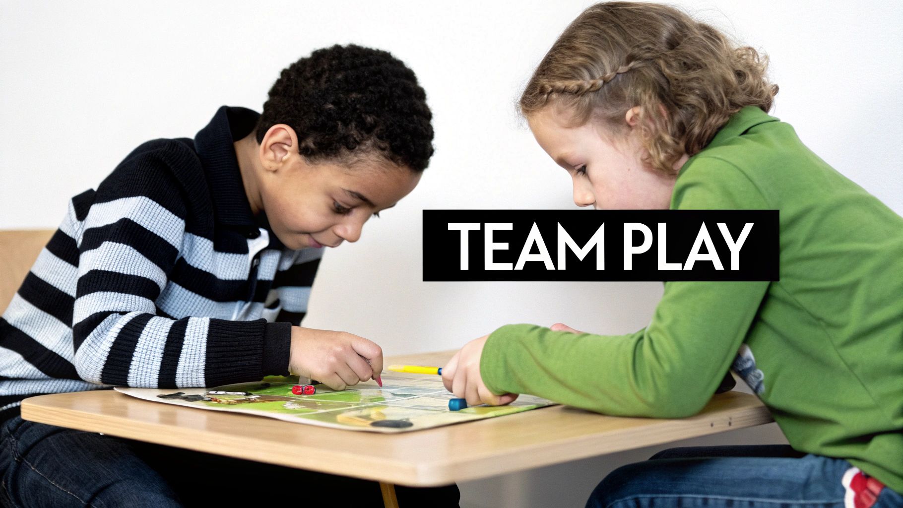 Two diverse children intently playing a board game together at a table, focused on teamwork.