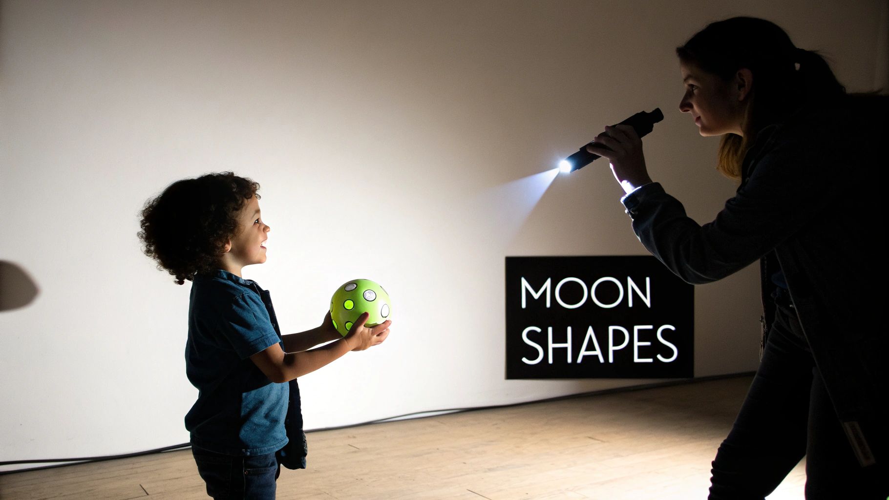 A child looking at the different phases of the moon in the night sky.