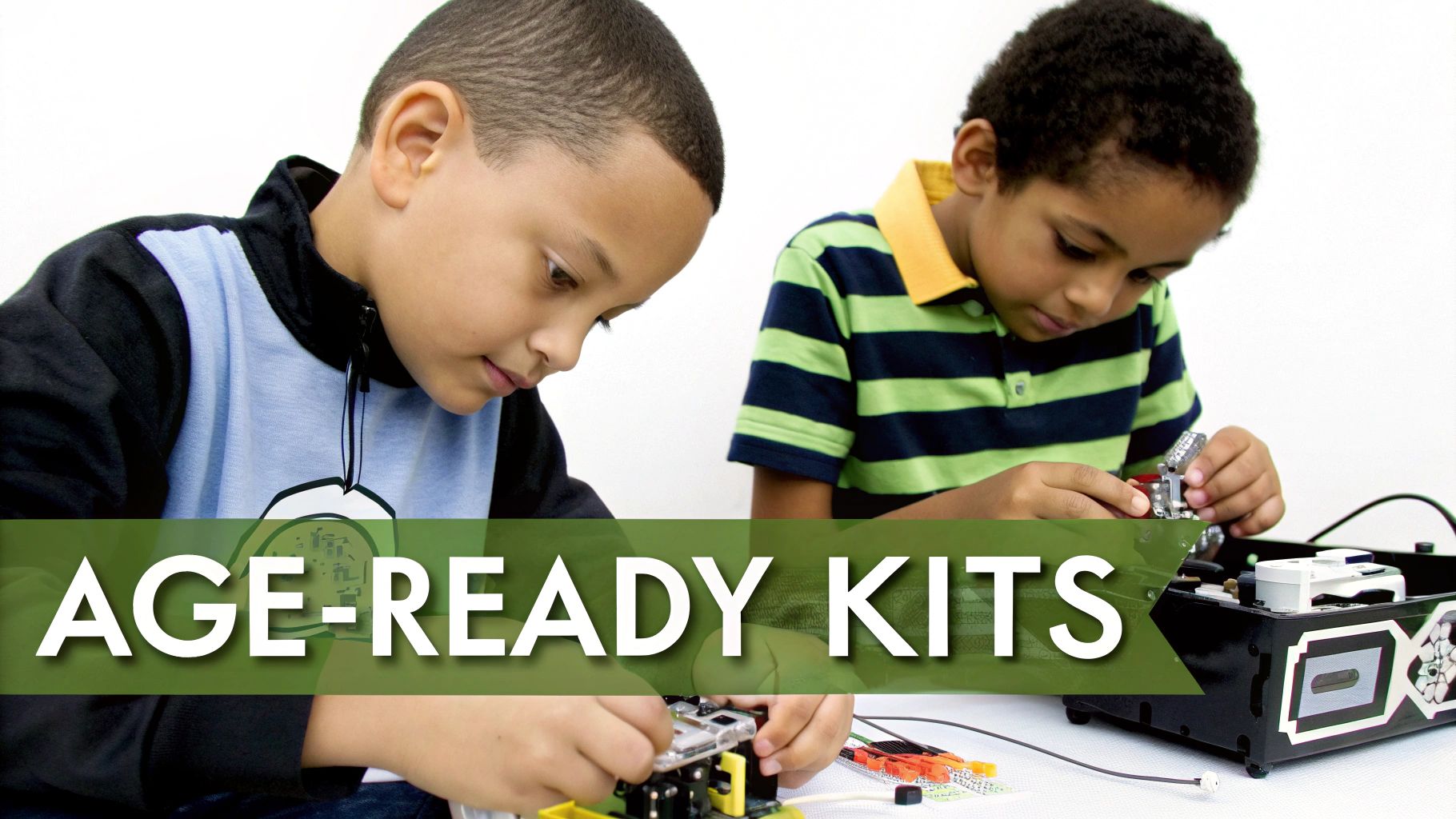 Two young boys assembling electronic components and robotics from age-ready educational science kits