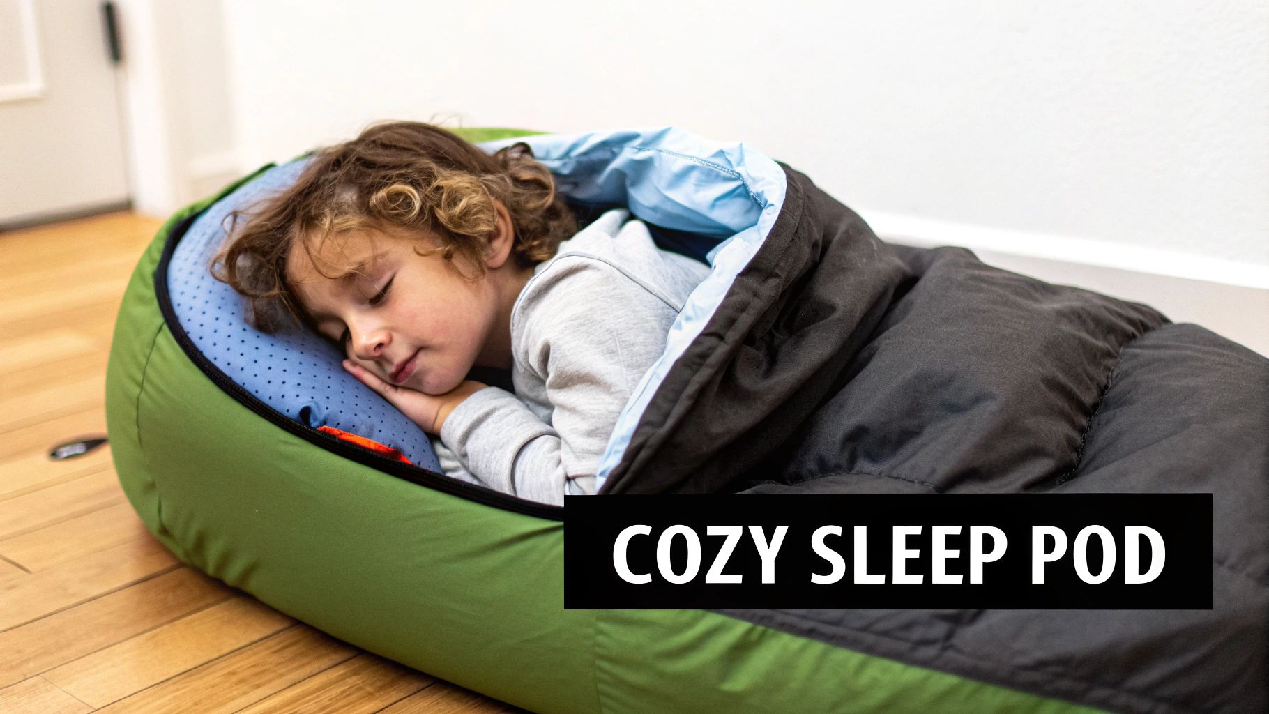 A young child happily lying in a themed childrens sleeping bag bed, ready for an adventure.