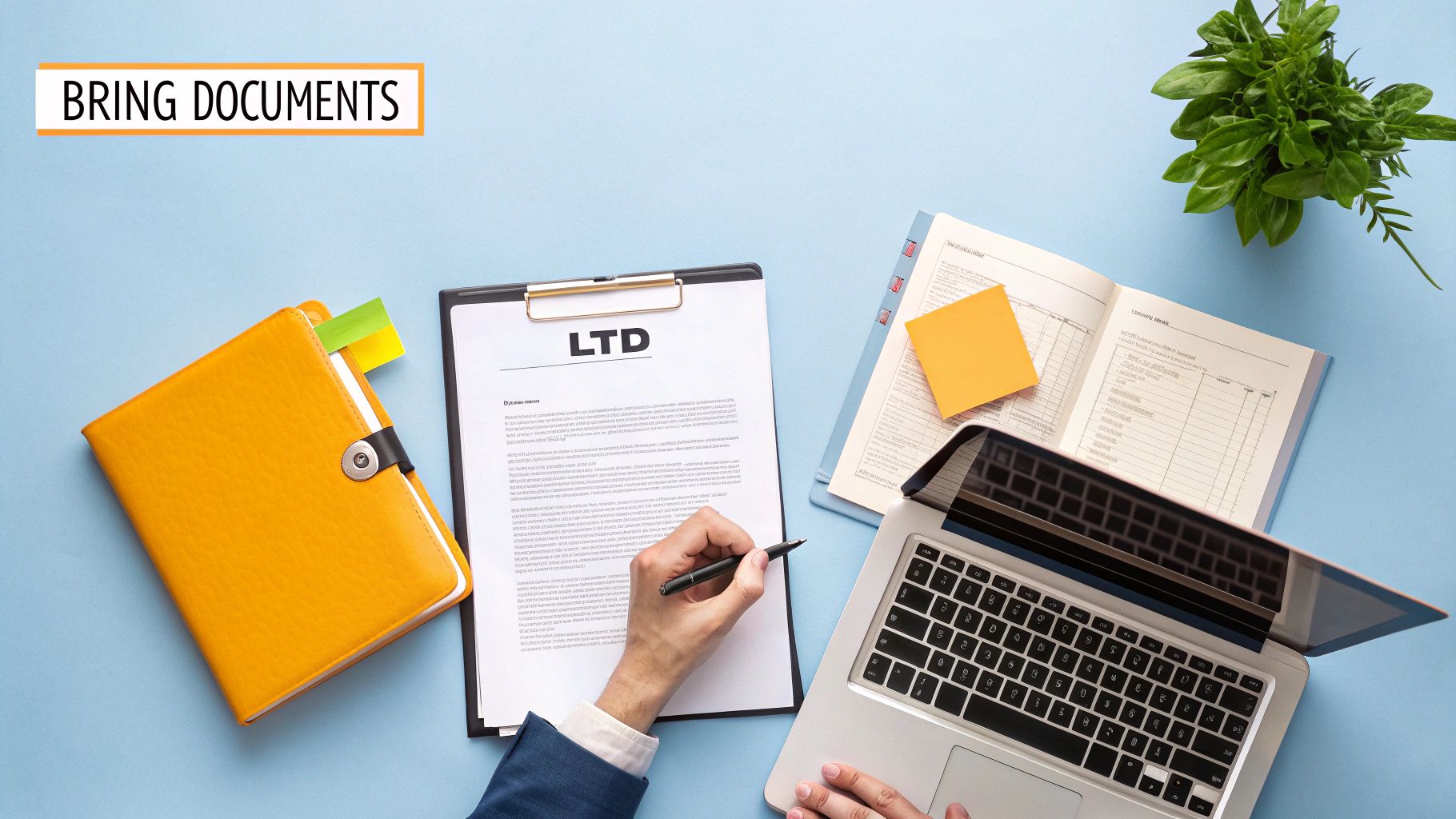 Person reviewing LTD documents with laptop and organized files on desk workspace