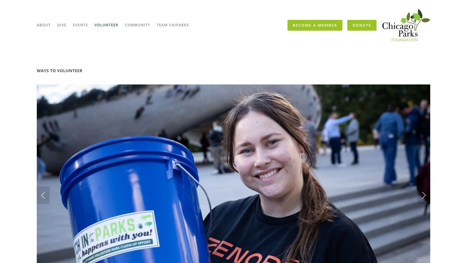 A group of volunteers with the Chicago Parks Foundation smiles for a photo while holding trash bags and tools after a park cleanup event.