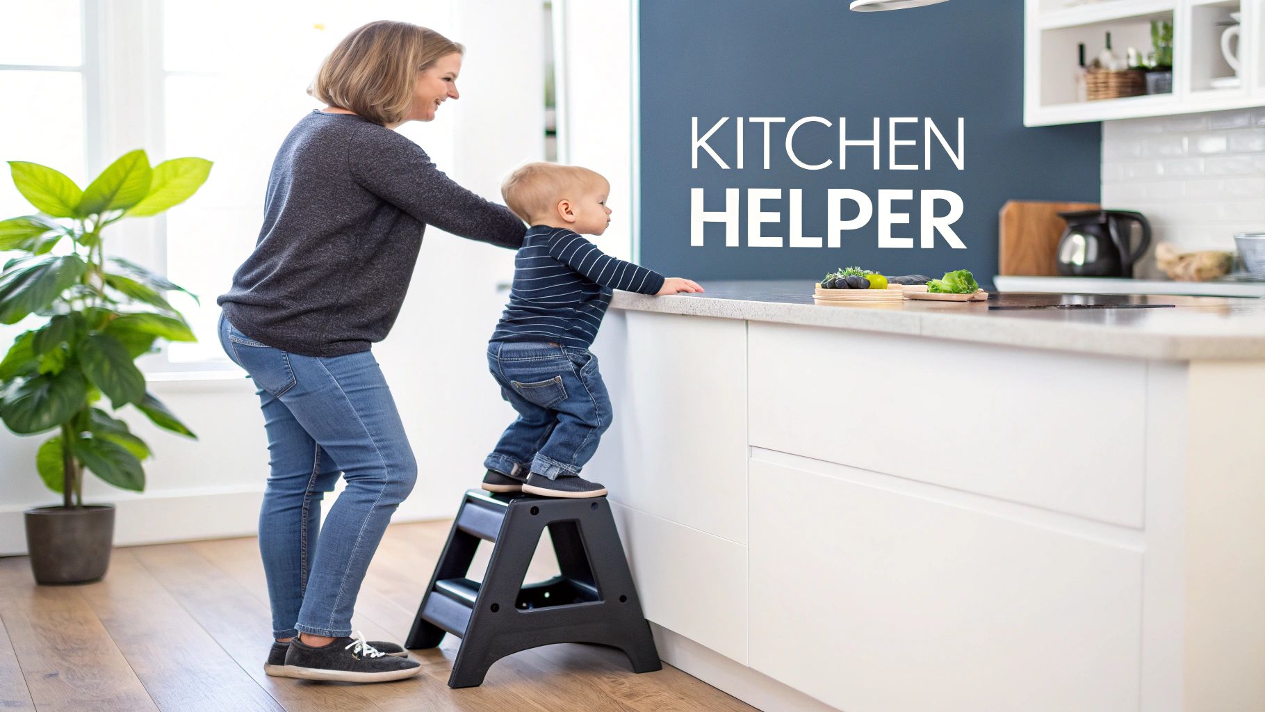 A happy child stands on a black step stool in a modern kitchen, reaching the counter with an adult.