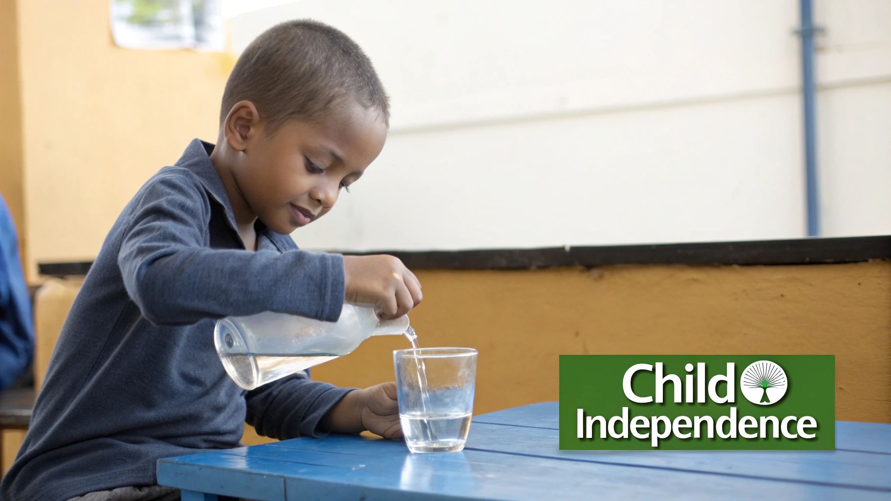 A young child carefully pouring water from one small pitcher to another, demonstrating a Montessori practical life activity.