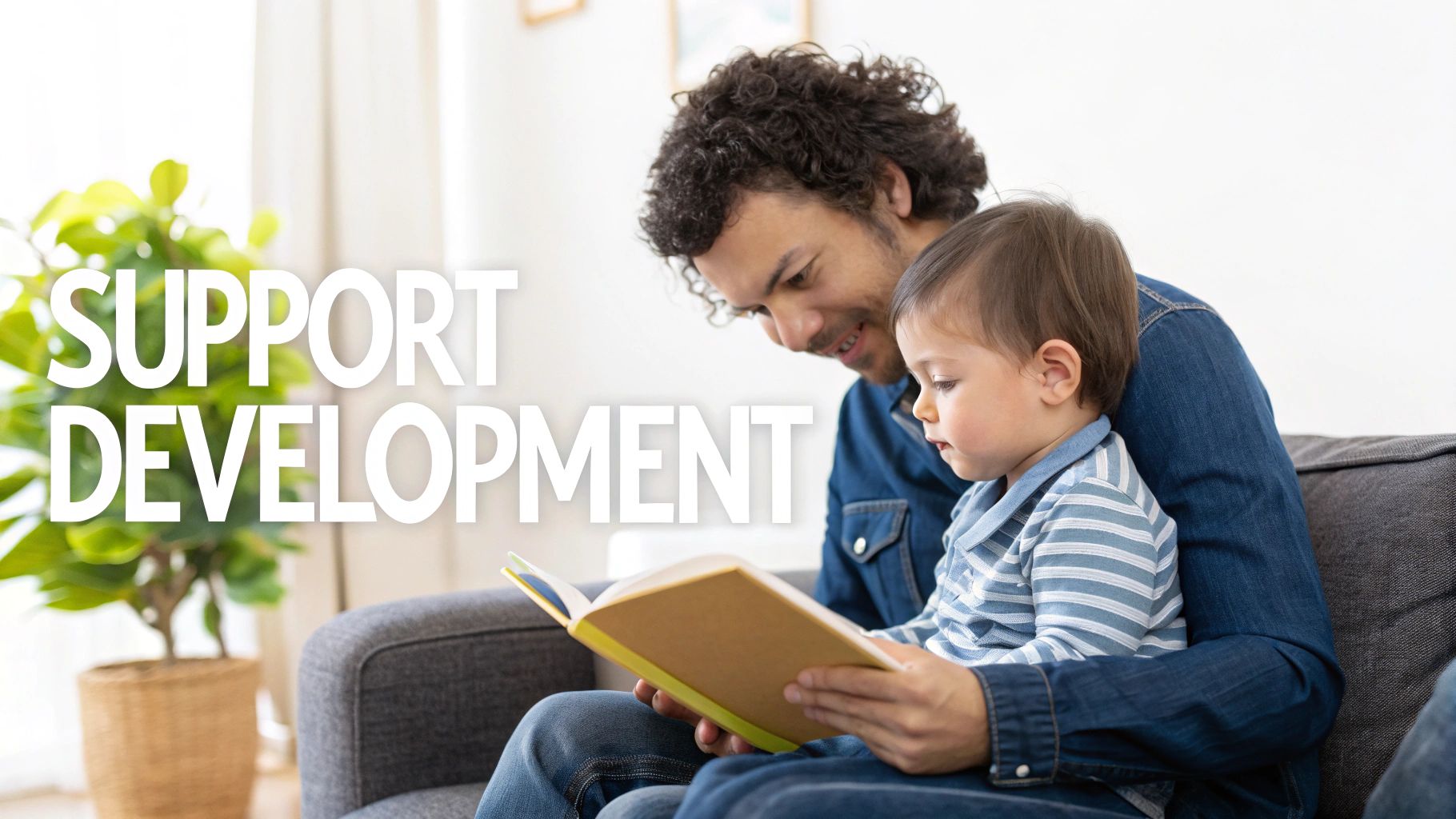 A parent and child are sitting on the floor, reading a colorful book together and smiling.