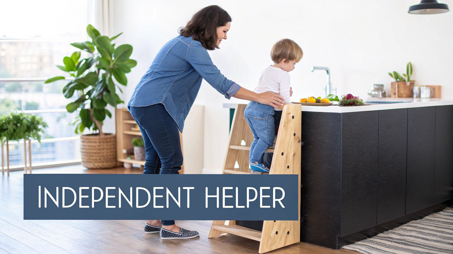 Mother helping young child safely climb Montessori learning tower in modern kitchen