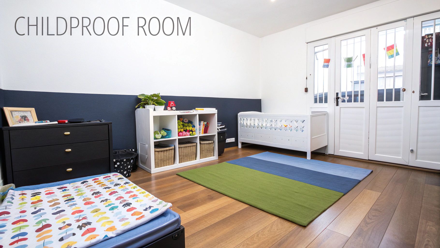 A bright childproof room featuring a white crib, a black dresser, and a colorful rug.