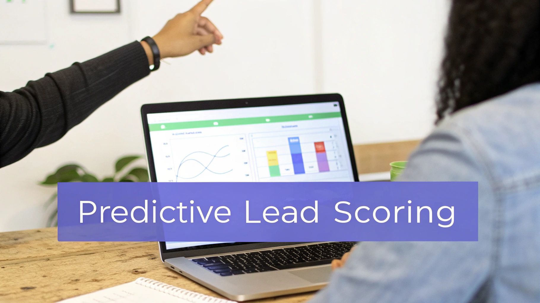 Two people discuss data on a laptop displaying 'Predictive Lead Scoring' in a collaborative workspace.