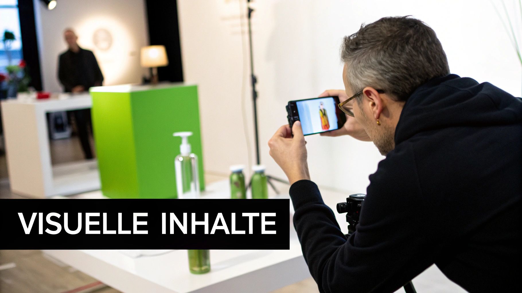 Man photographs products with smartphone at trade fair booth for visual content and marketing.