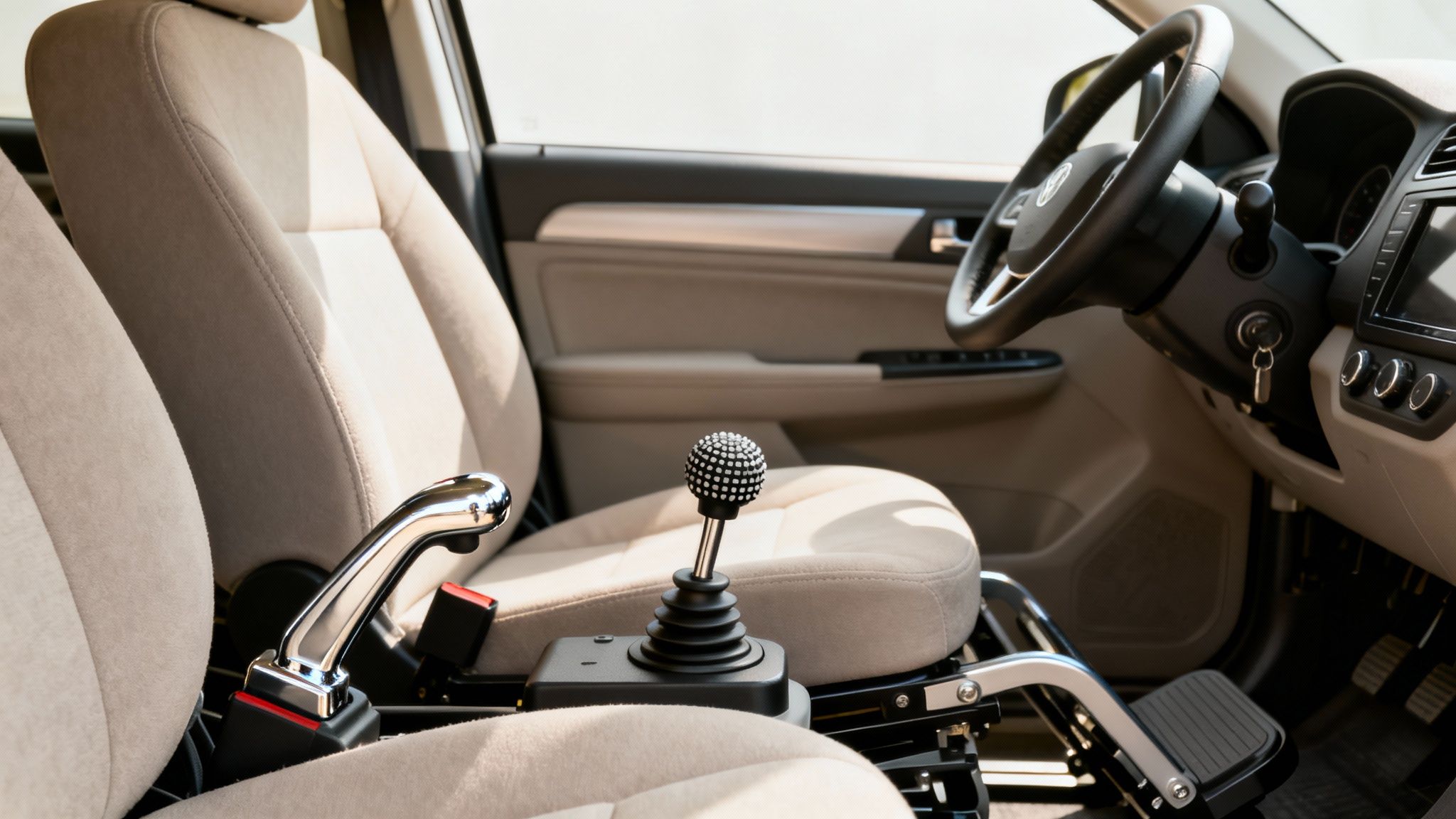 Car interior with adaptive driving controls, featuring a joystick shifter and chrome lever.