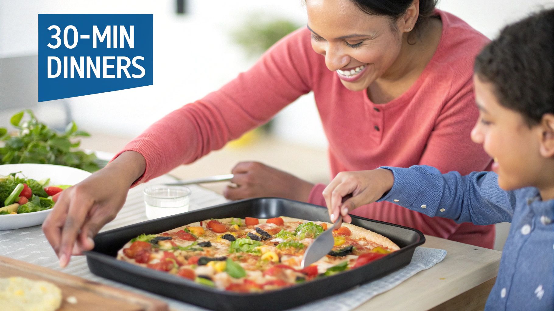 Smiling mother and son serving fresh pizza and salad for a quick family dinner.