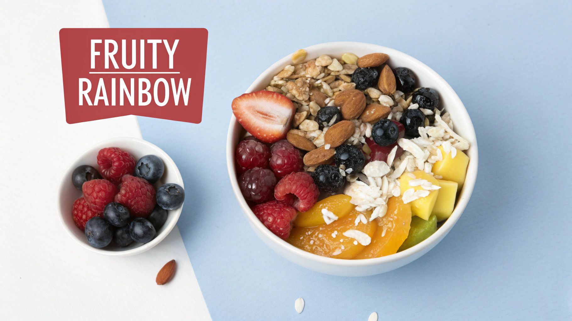 Colorful fruity rainbow breakfast bowl with granola, fresh berries, nuts, and tropical fruit toppings
