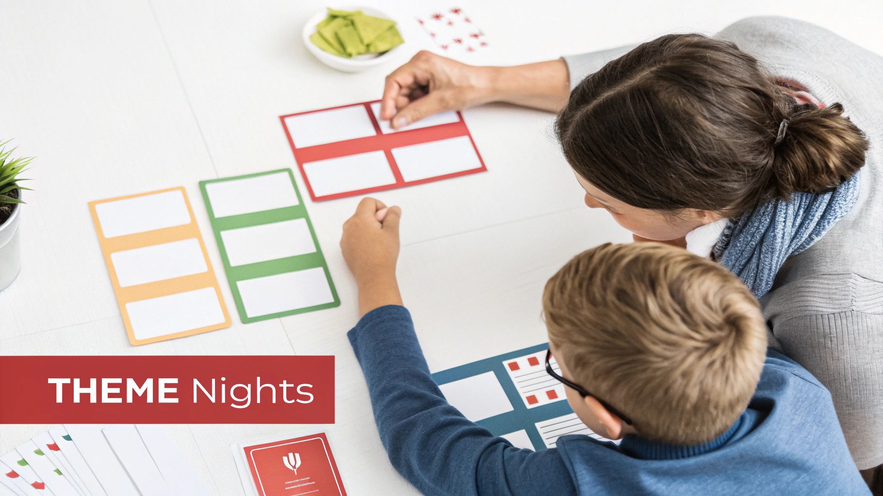 Adult and child arrange colorful cards on a table, engaged in a theme night planning activity.