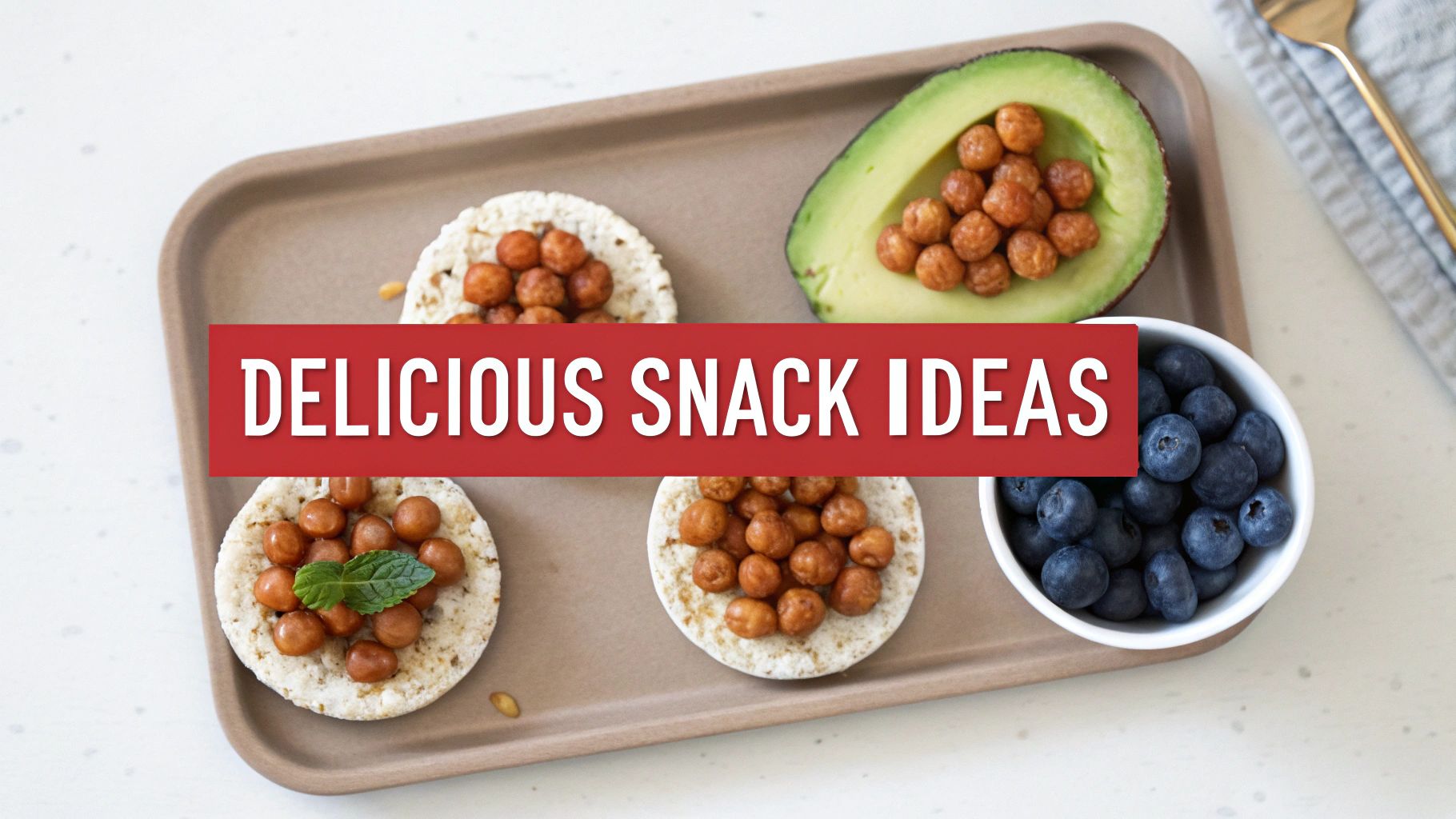 A tray of delicious and healthy snack ideas, including rice cakes with chickpeas, avocado, and blueberries.