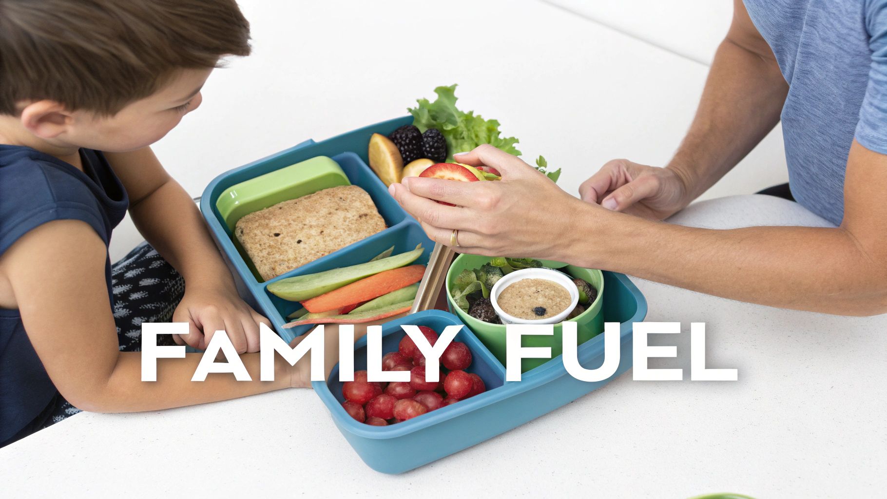 A child and an adult fill a segmented lunchbox with healthy foods like fruits, vegetables, and a sandwich.