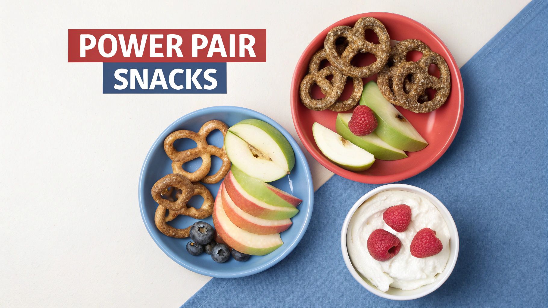 Overhead view of power pair snacks: pretzels, apples, berries, and yogurt on colorful plates.