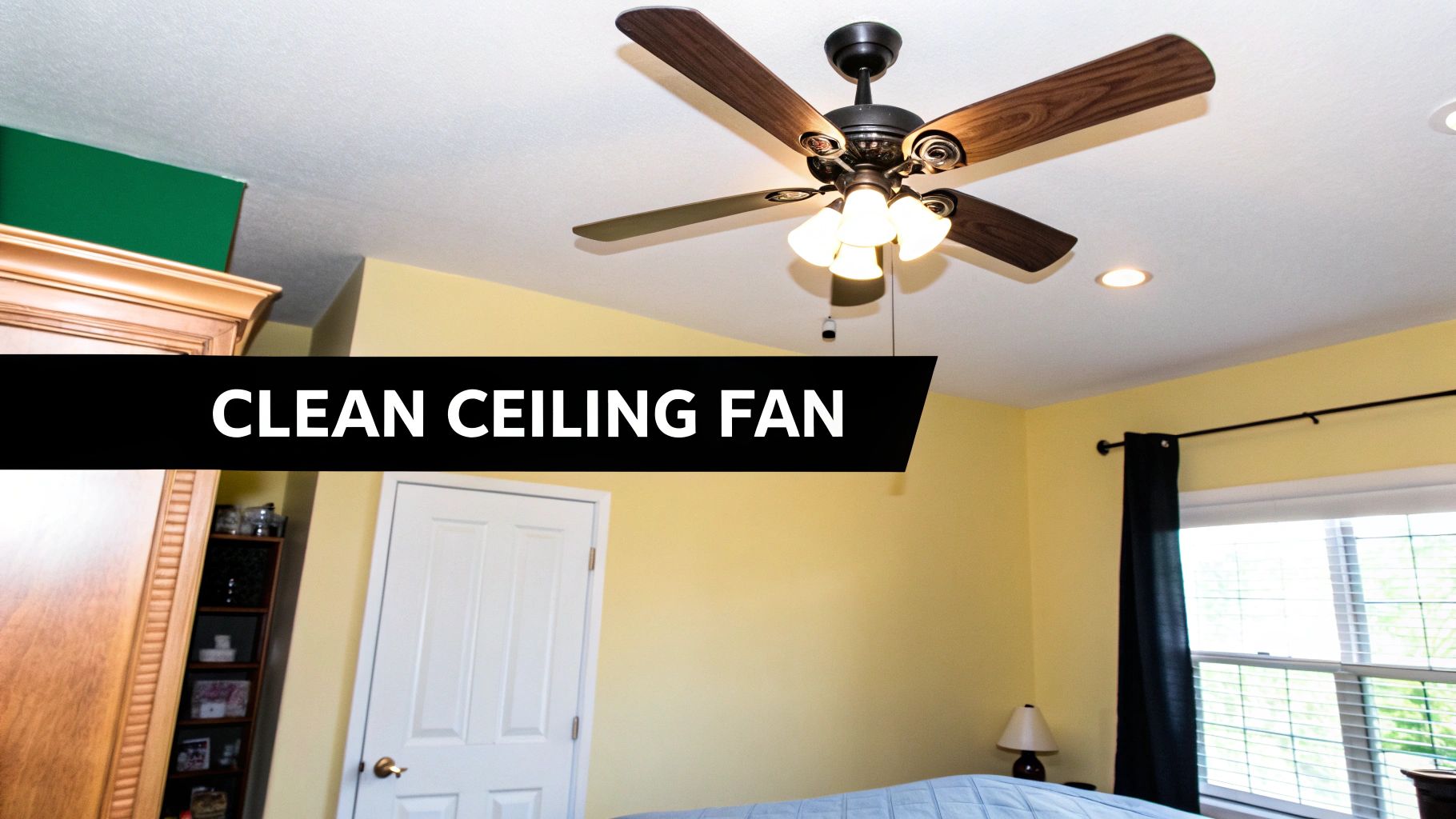 A person using a specialized duster to clean the blades of a white ceiling fan, showcasing a safe and effective cleaning method.