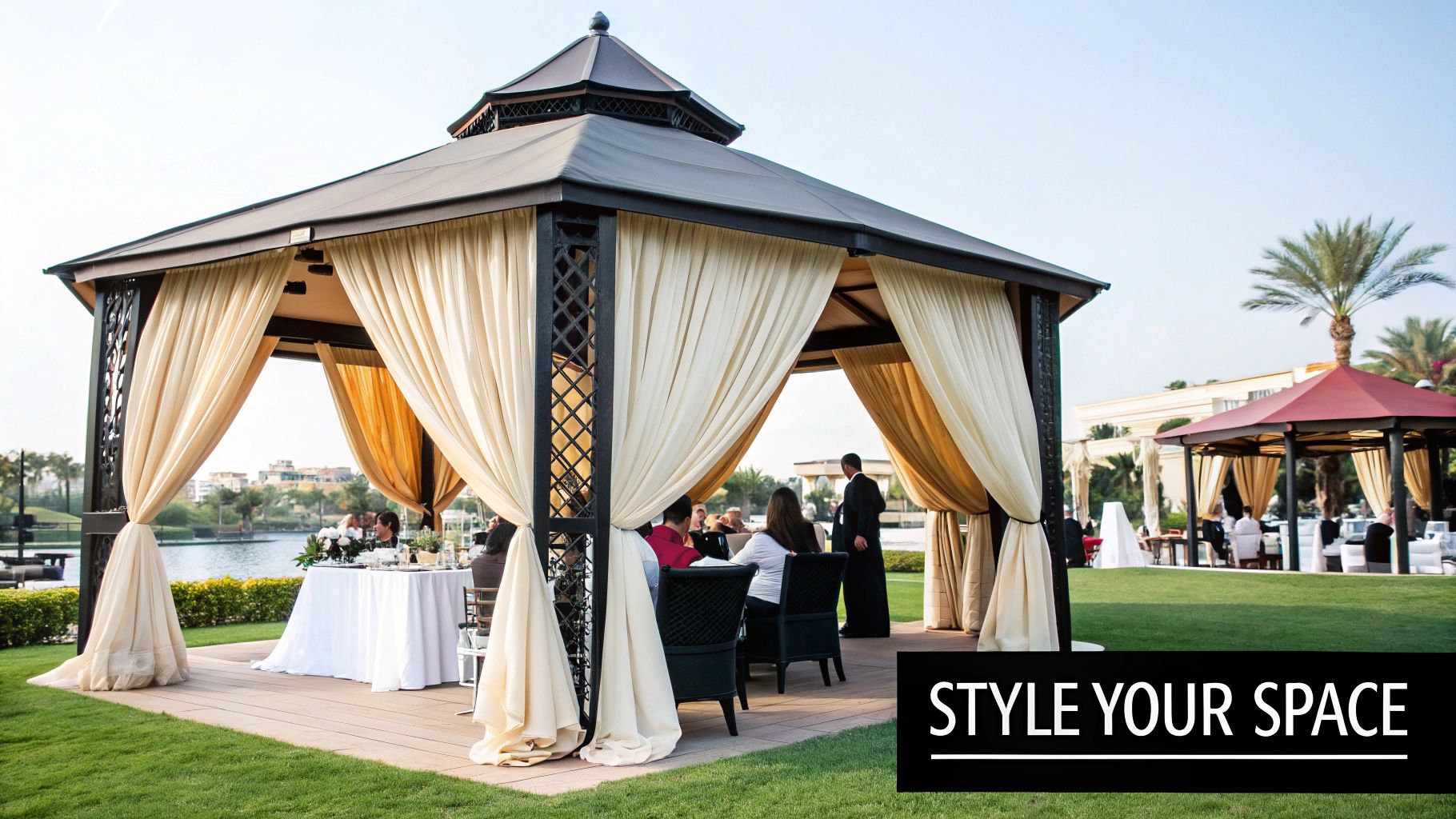 A beautifully decorated heavy duty gazebo with fairy lights and elegant drapery for a night-time event.