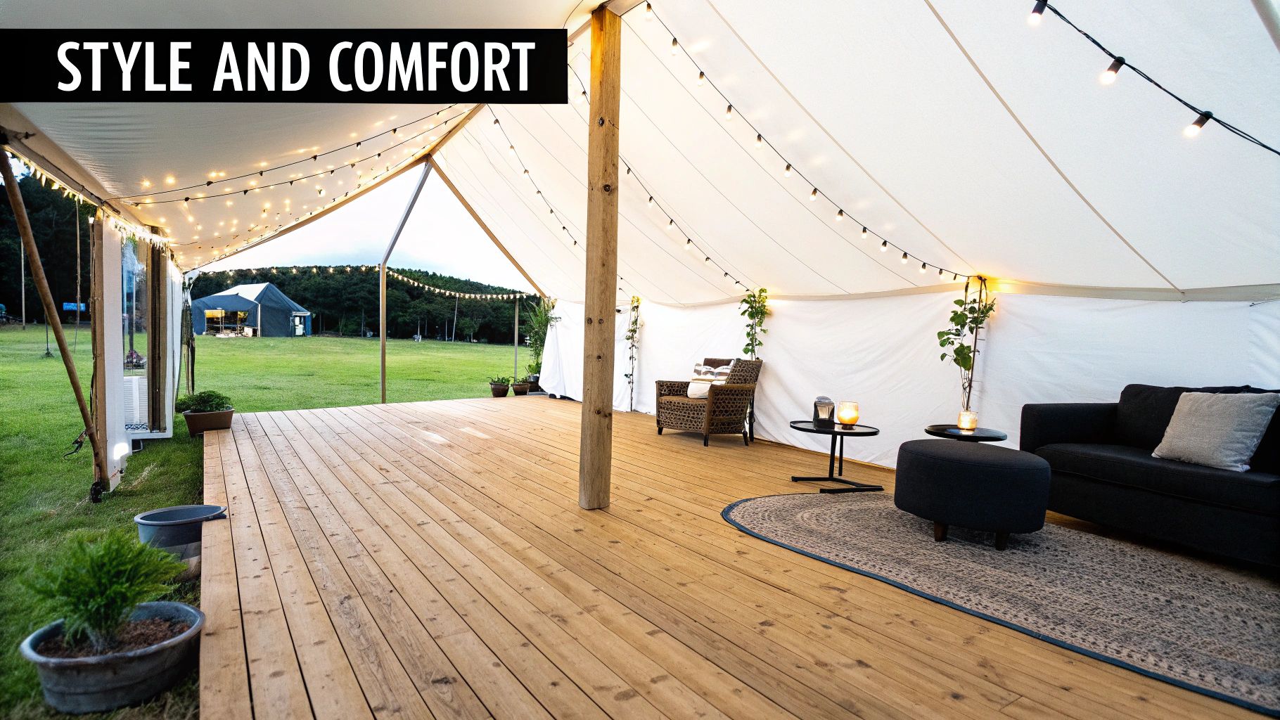 A party tent decorated with elegant flooring, lighting, and comfortable seating