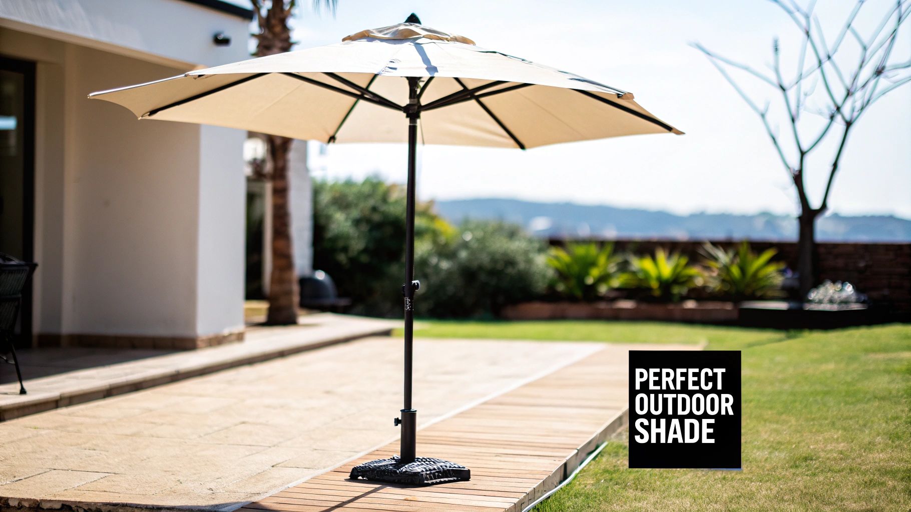 A large beige patio umbrella with a dark stand provides shade over a comfortable outdoor seating area.