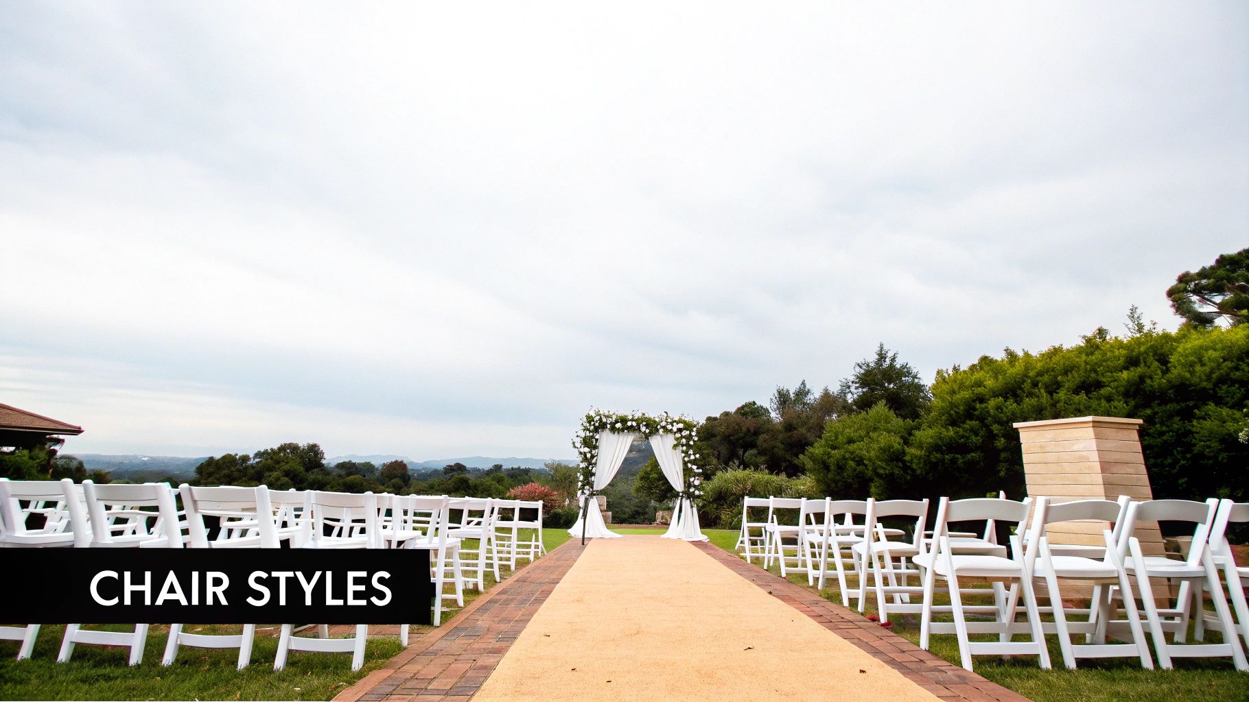 Rows of elegant white wedding chairs set up for an outdoor ceremony.
