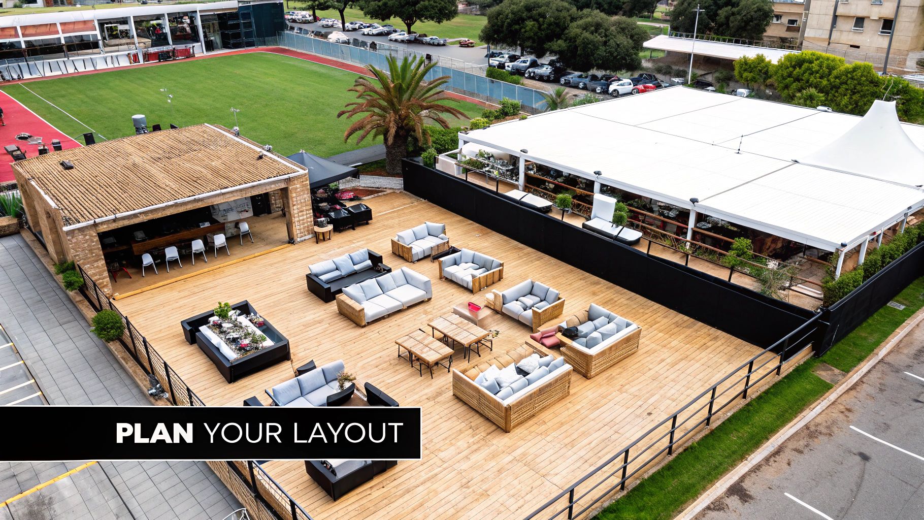 Aerial view of a spacious outdoor event deck with stylish lounge furniture and a bar.