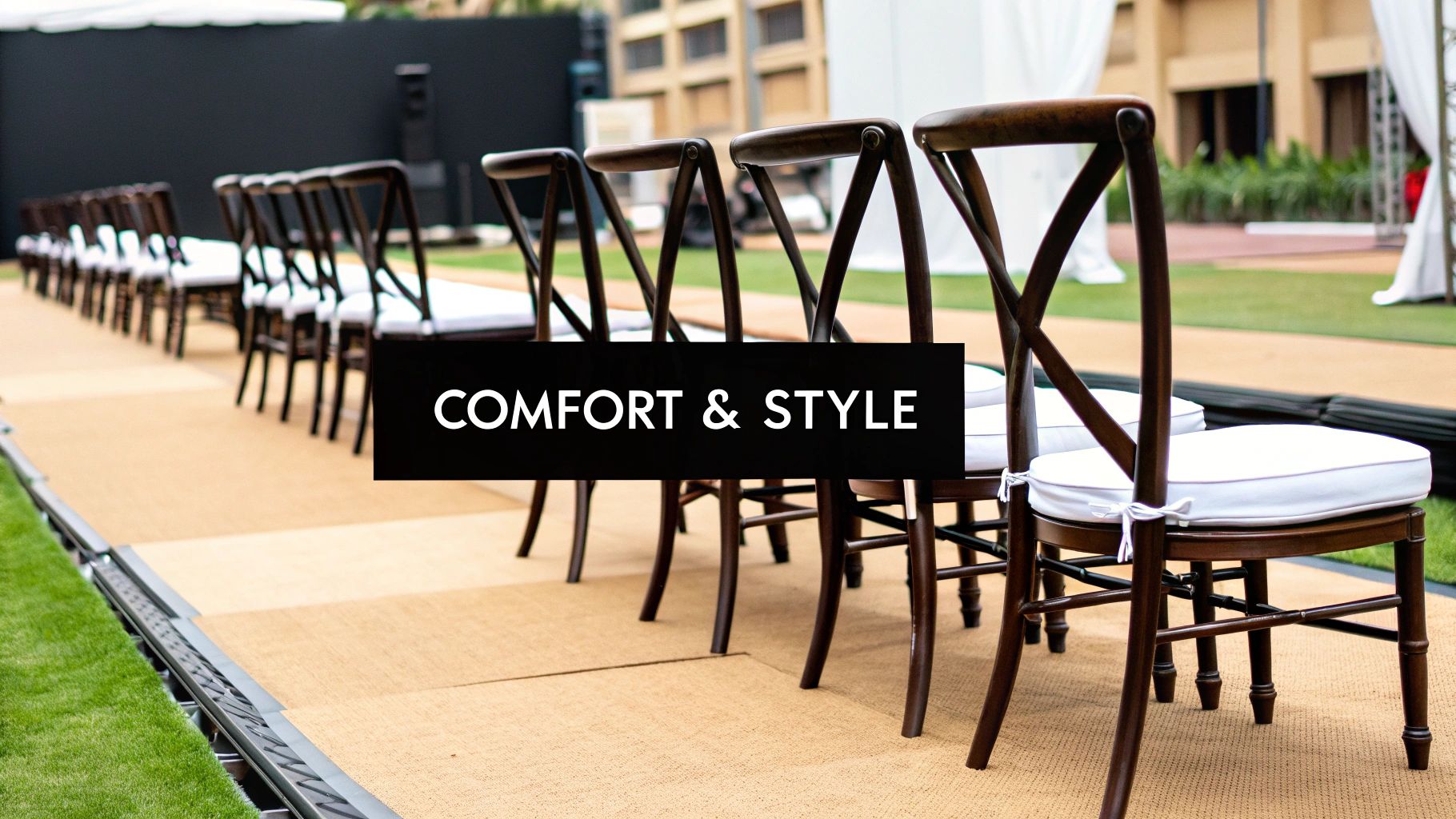 Elegant white chairs set up for an outdoor event ceremony