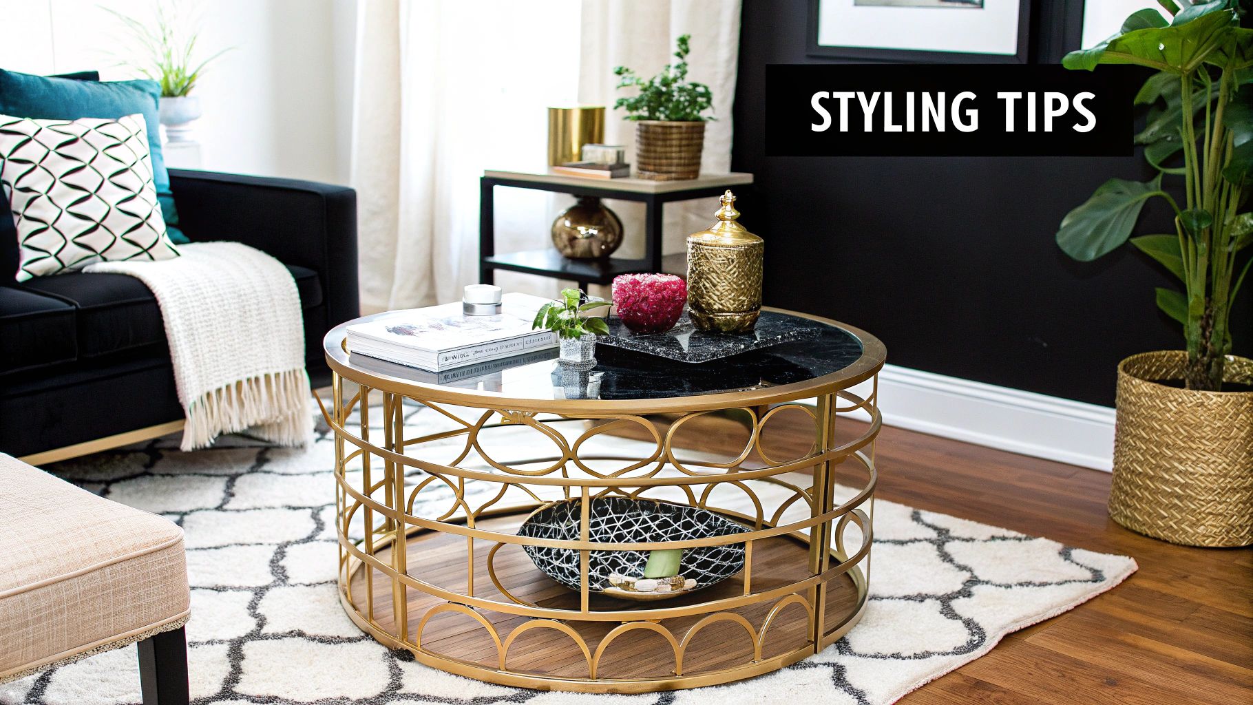 A beautifully styled gold cocktail table with a vase of fresh flowers, a stack of books, and a decorative object.