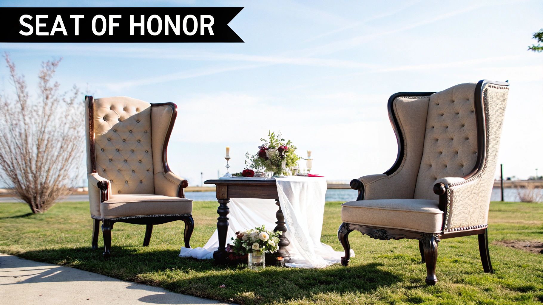 Two elegant wing back chairs creating an intimate seating area at a stylish event.