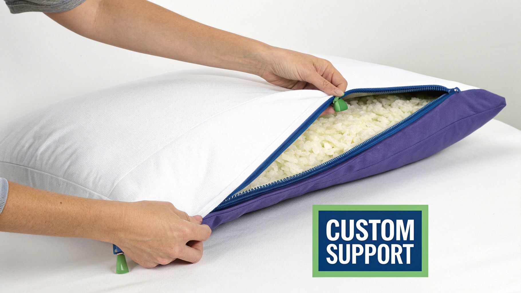A person's hands unzipping a pillow to show shredded foam fill for custom support.