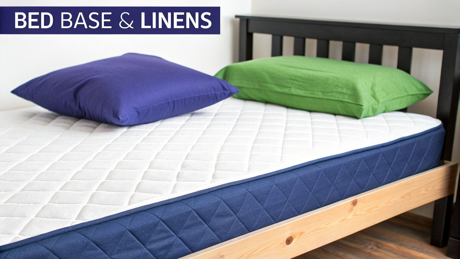 A single bed with a white mattress, blue base, a purple and a green pillow.