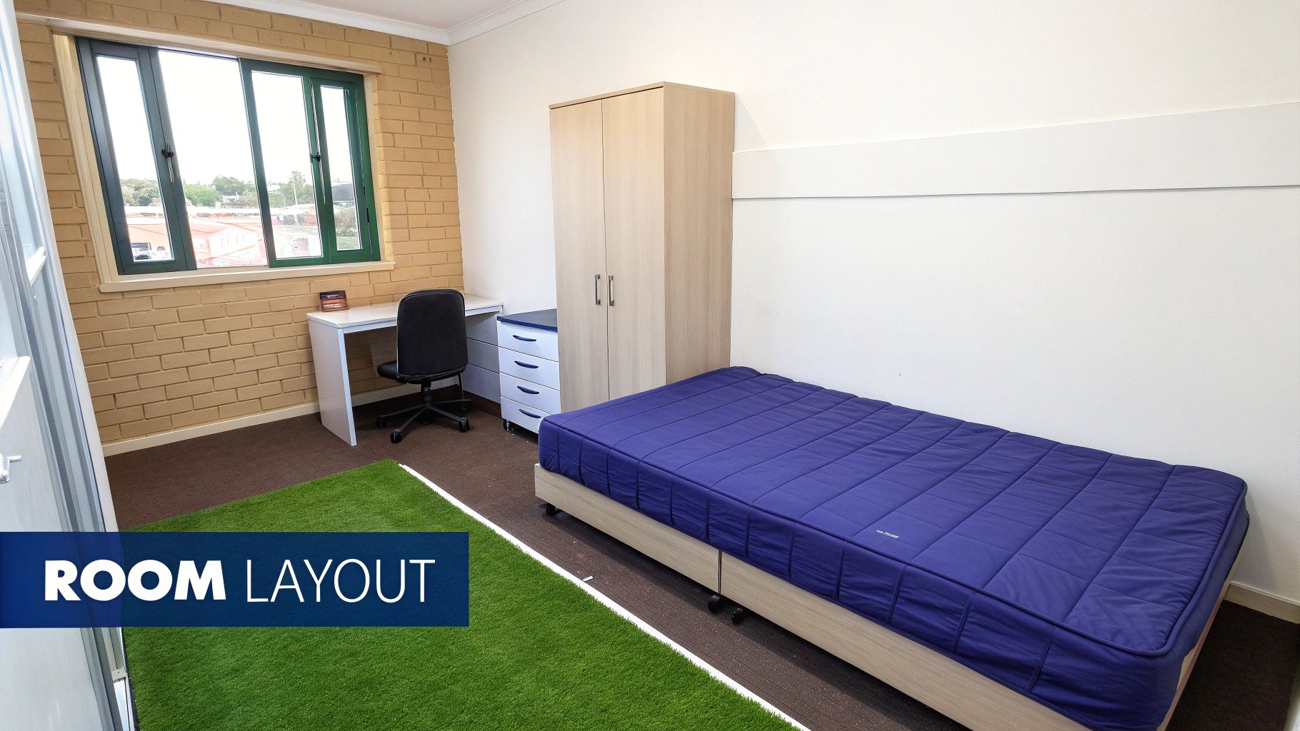 A furnished student bedroom with a single bed, desk, chair, wardrobe, and drawers. A window on a brick wall.