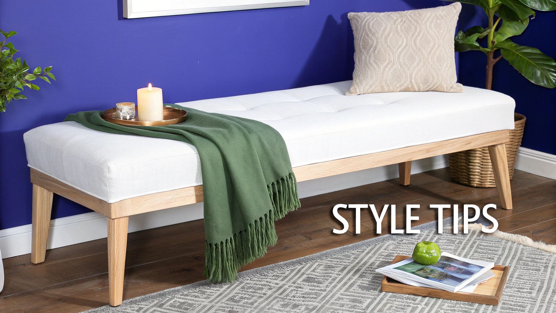 A stylishly arranged foot of bed bench with a throw, books, and a tray.