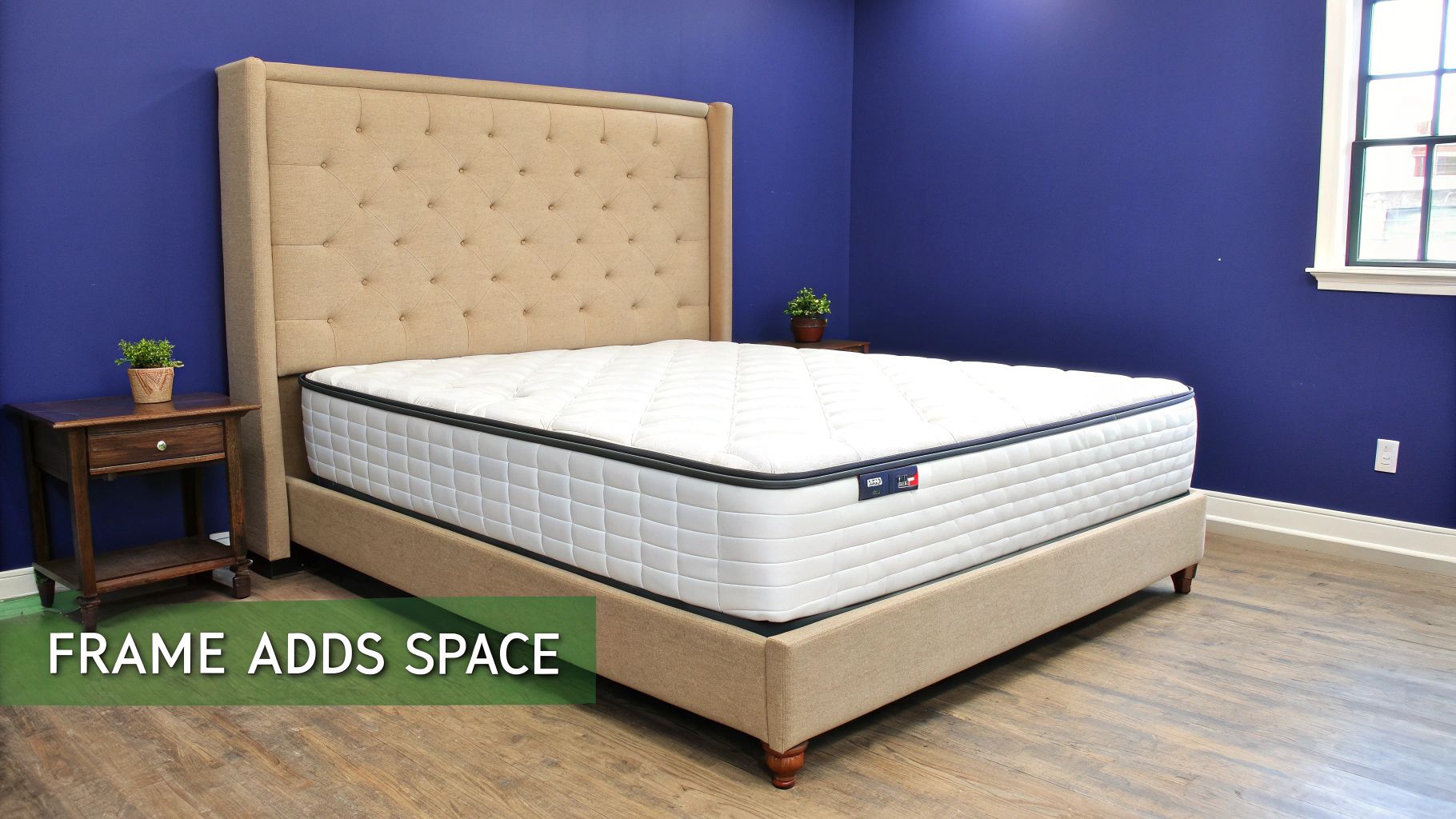 Elegant king-size bed with beige tufted headboard, white mattress, and two nightstands in a blue room.