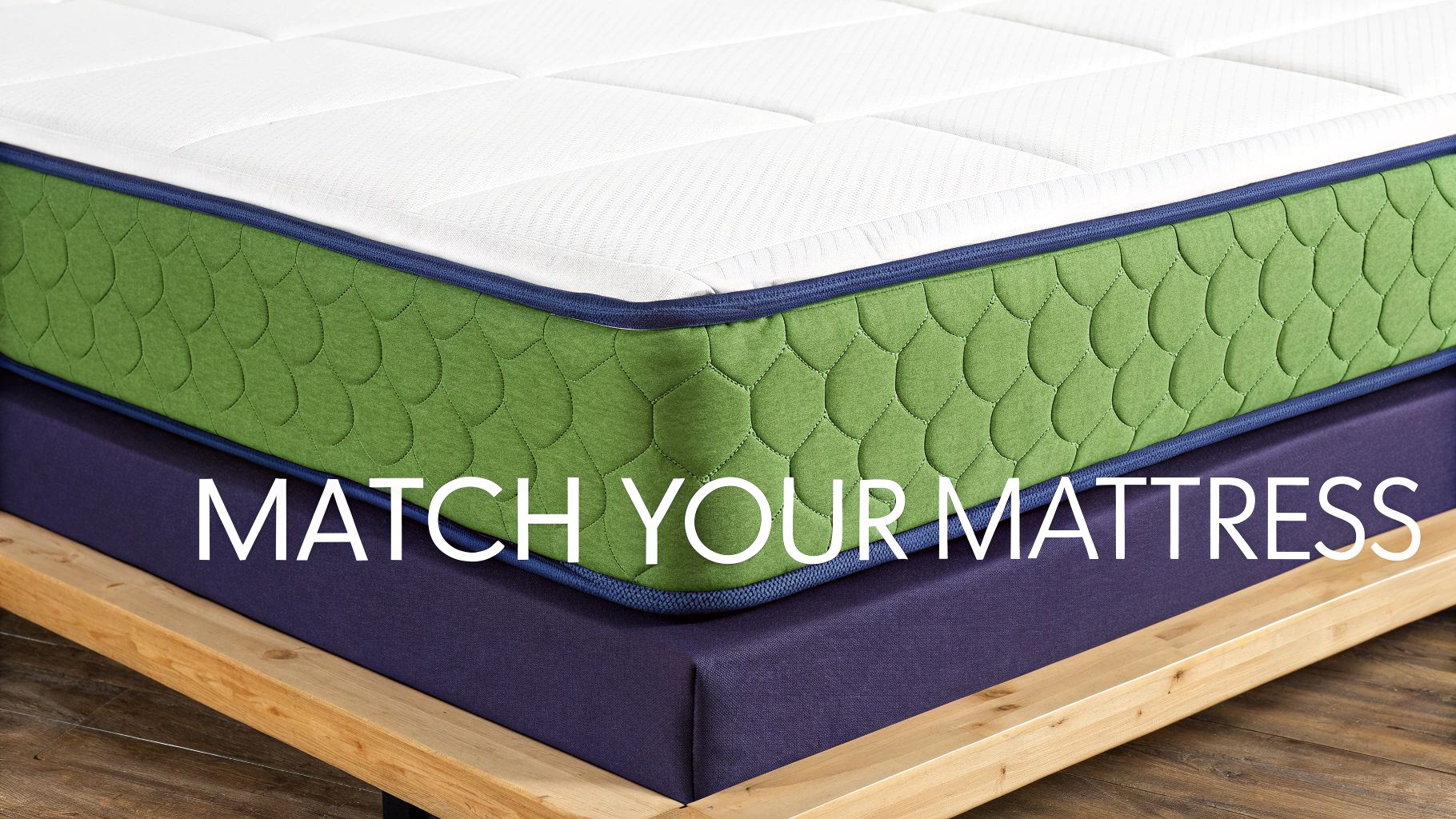 A green and white mattress with blue trim rests on a purple bed base and wooden frame.