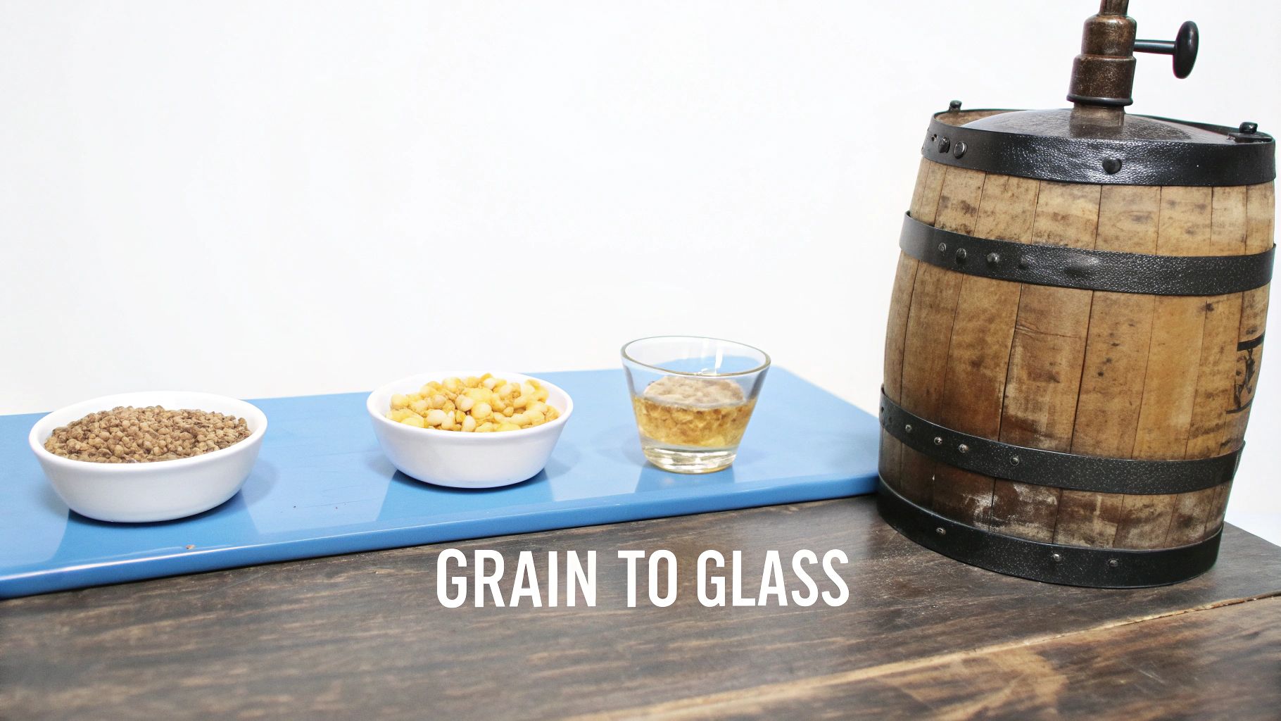 Grain to glass whiskey production process showing barley, corn, and finished bourbon with wooden barrel