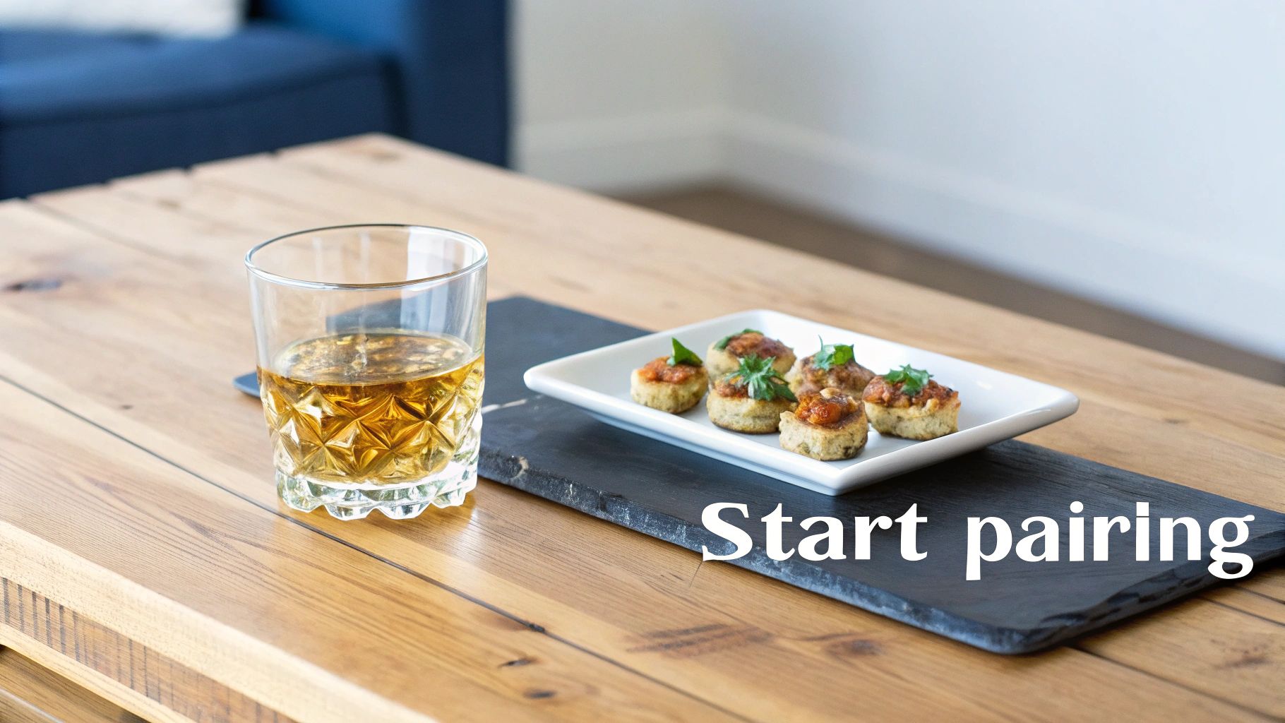 A glass of whisky and a plate of appetizers ready for a food pairing.