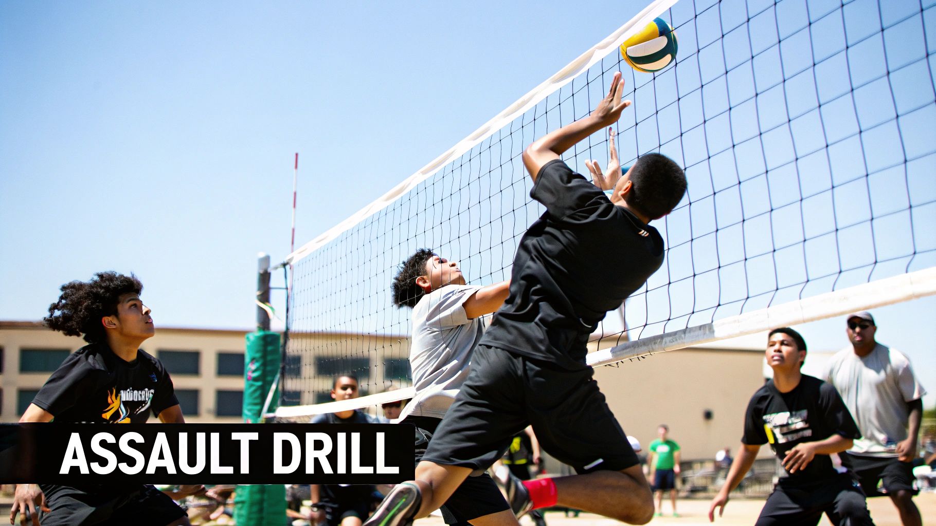 Youth volleyball players in action, one jumping to hit the ball over the net during an outdoor drill.