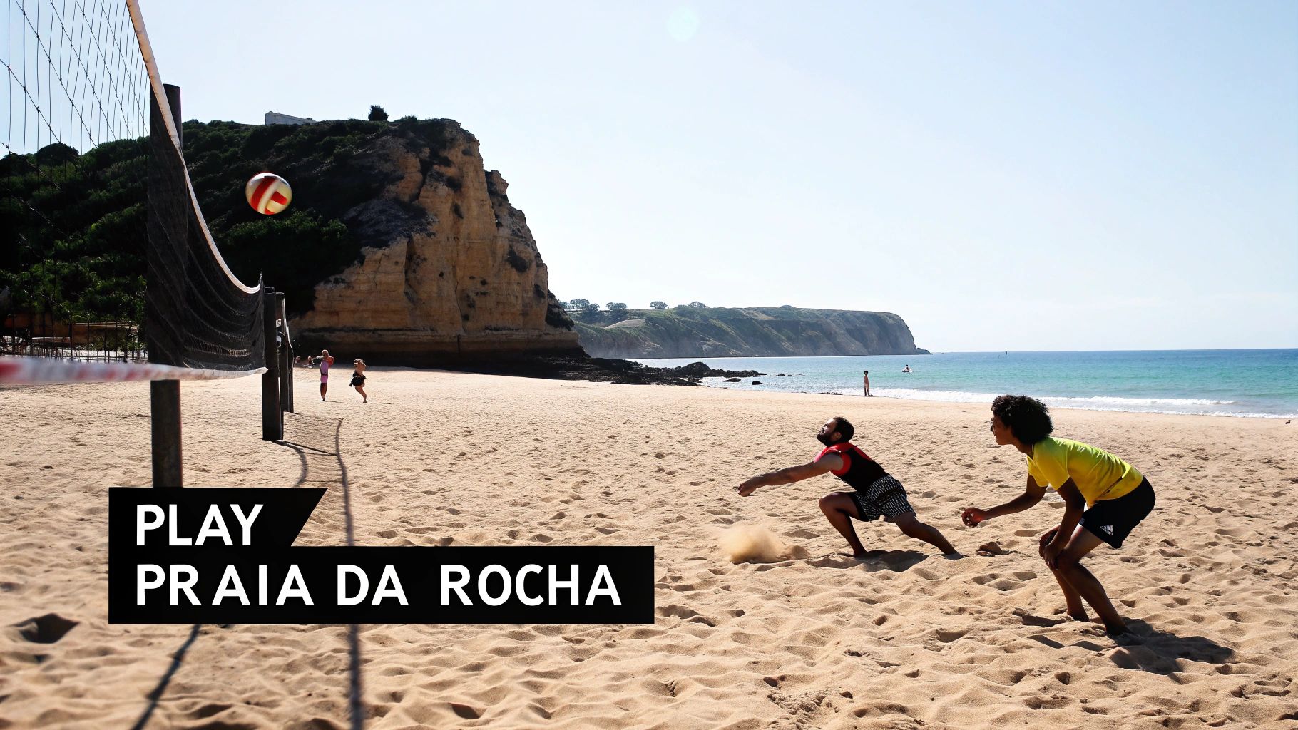 Beach volleyball players diving for a ball on a sunny beach at Praia da Rocha, Portimão.